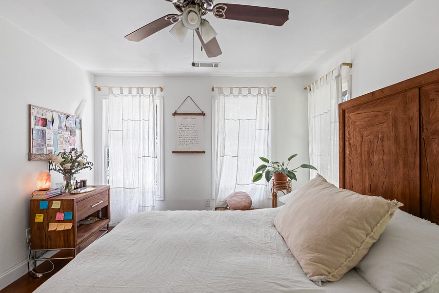 primary bedroom with bathroom. (note the furniture will be different, the house just completed renovations but this is the space)