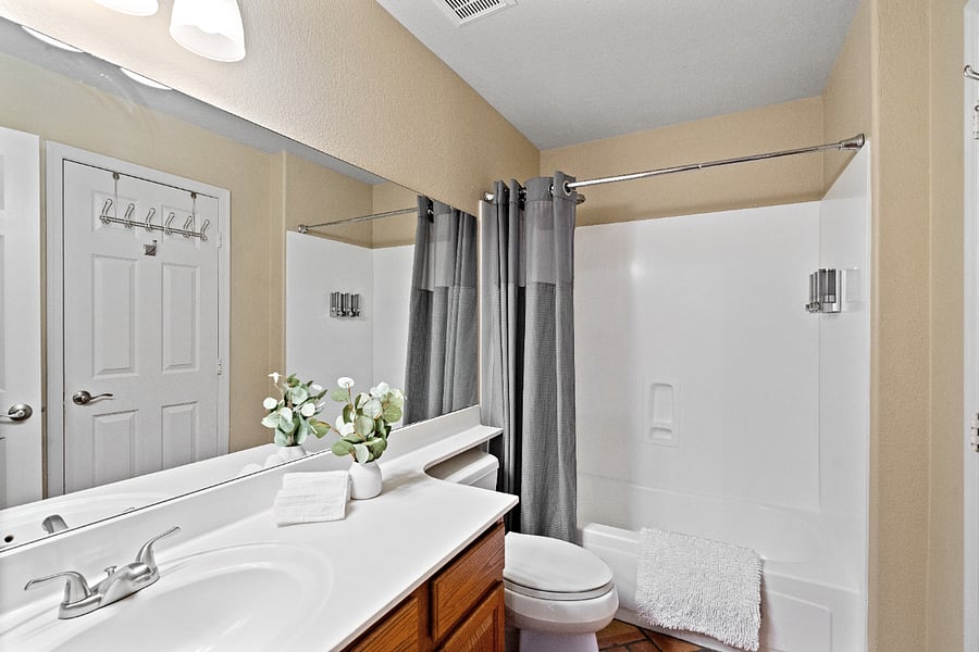 The downstairs full bathroom is conveniently located on the main level and is easily accessible from both the hallway and the downstairs bedroom. It features a bathtub and shower combination, a vanity, and all the essentials needed for a comfortable stay.