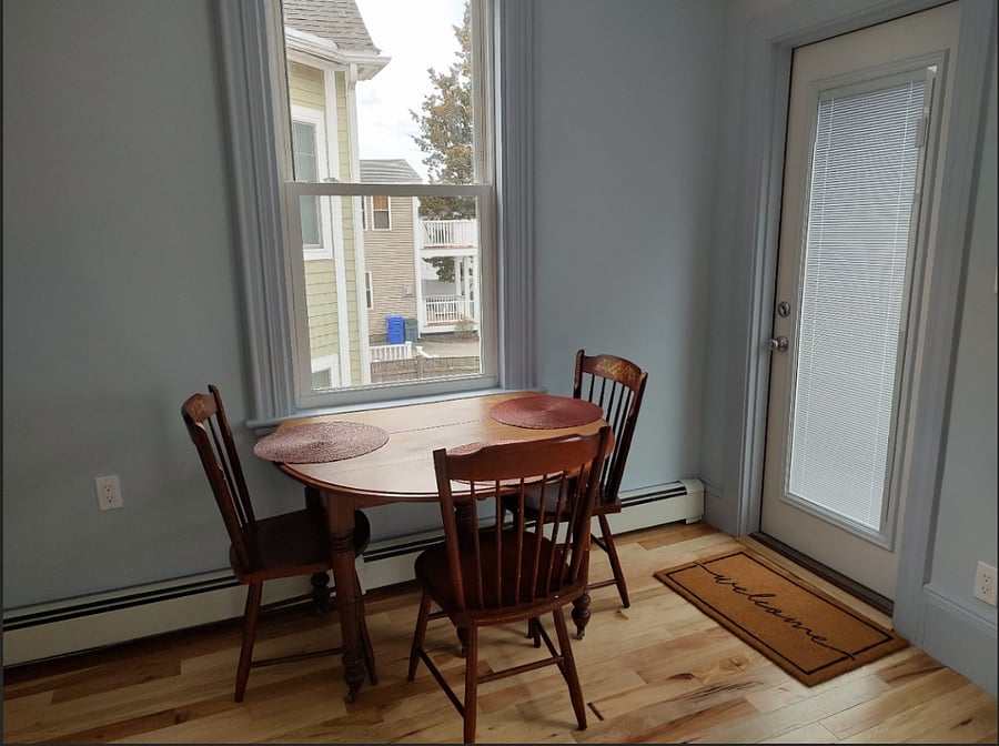 Kitchen with door leading to tiny porch and backyard.