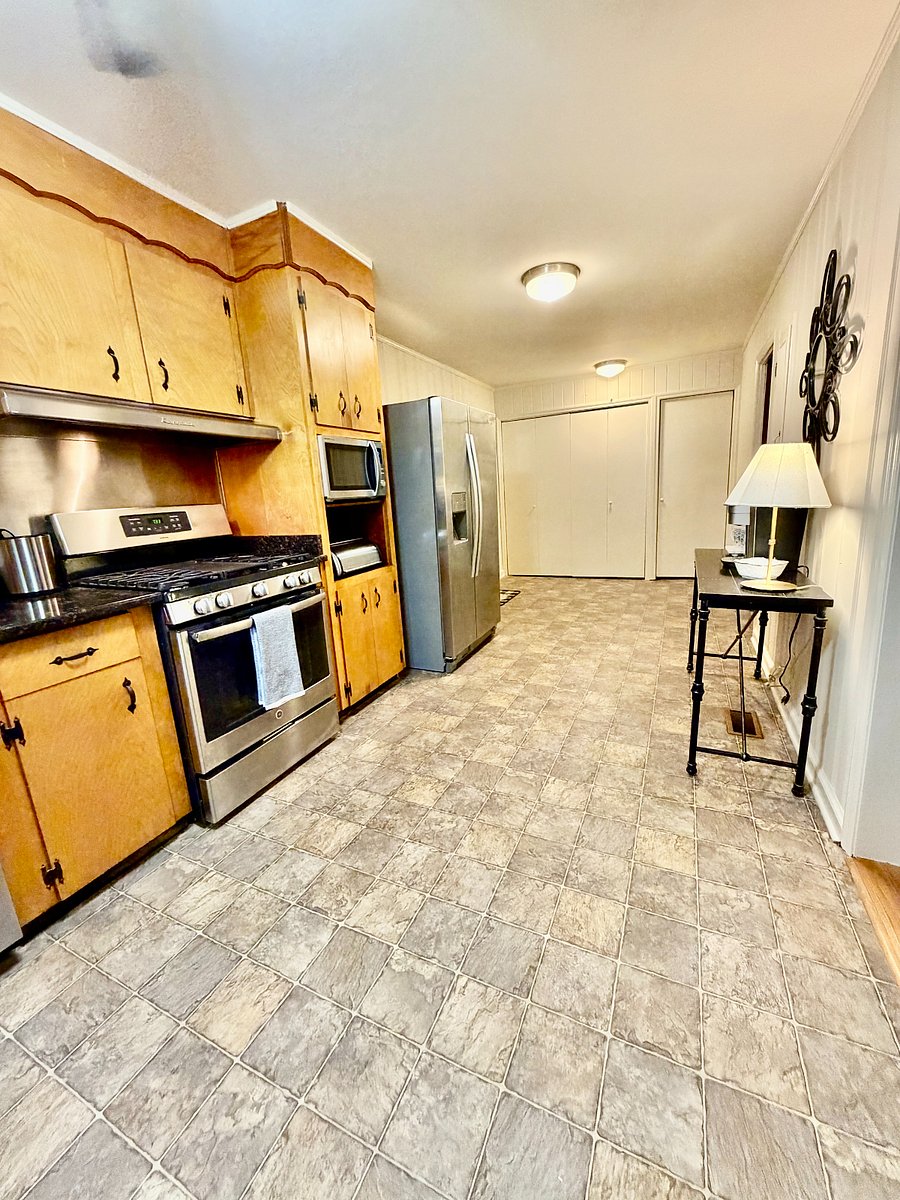 The kitchen has a full-size washer and dryer behind closet doors.