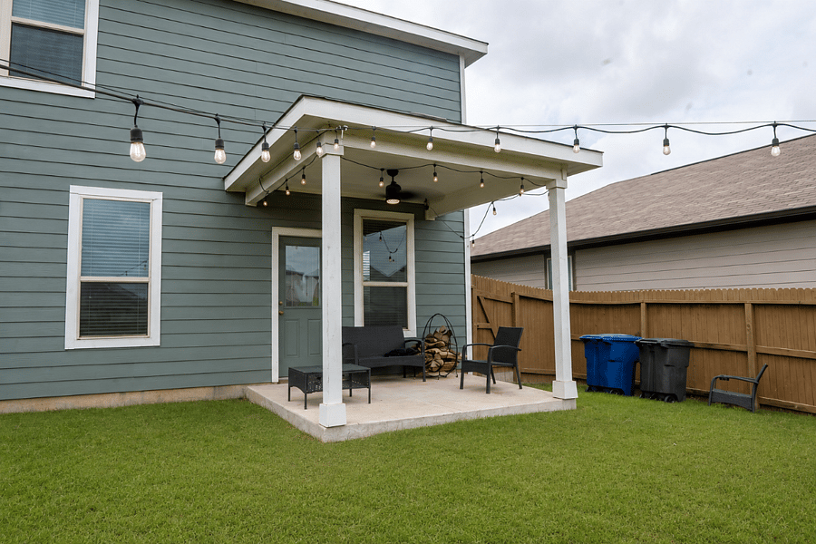 Covered Backyard Patio with Outdoor Seating and Ambient String Lighting