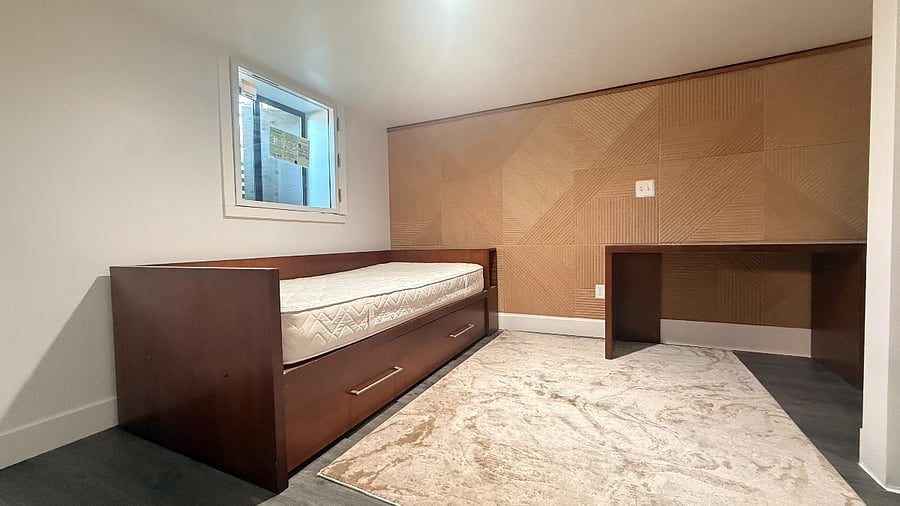 Bedroom 2 with desk, acoustic panel, double window, and window shutters black out.