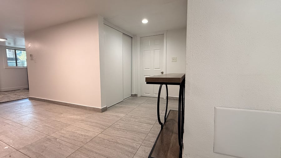 Home entryway. Room door and utility room door.