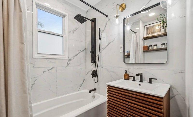 2nd floor bathroom - which services all three bedrooms. Includes shower/tub combo, vanity and toilet.