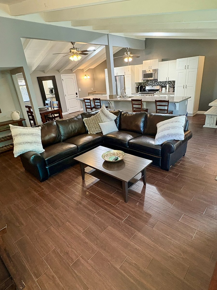 An oversized leather sectional flows into the dining area and directly into the kitchen beneath dramatic exposed beam vaulted ceilings. Spacious, warm and full of character.