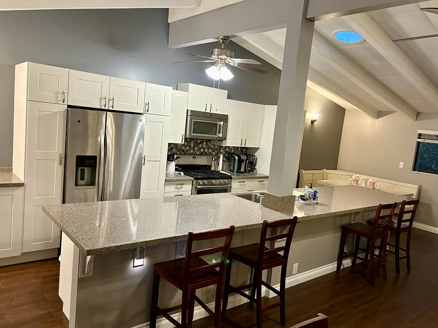 The kitchen is the focal point of the room where everyone gathers with plenty of seating.
