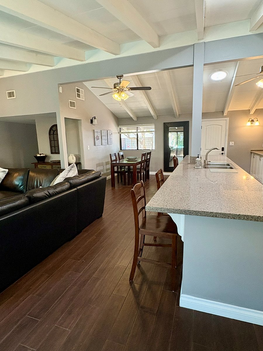 The vaulted beam ceilings tie living, dining and kitchen into a single expansive flow - open and airy.