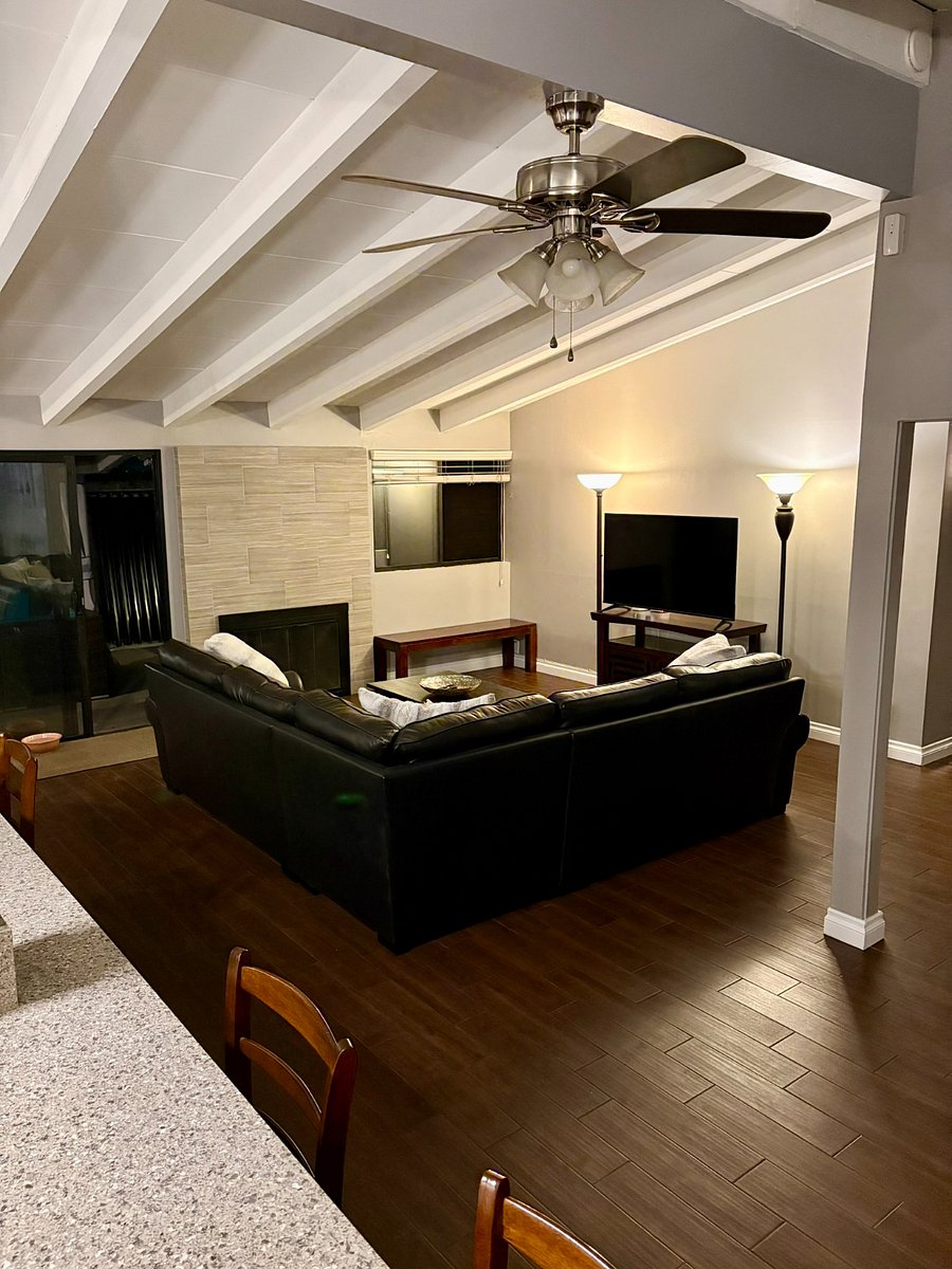 At the end of the day, sink into the sectional. Vaulted beams overhead and warm lighting - this is what coming home feels like.