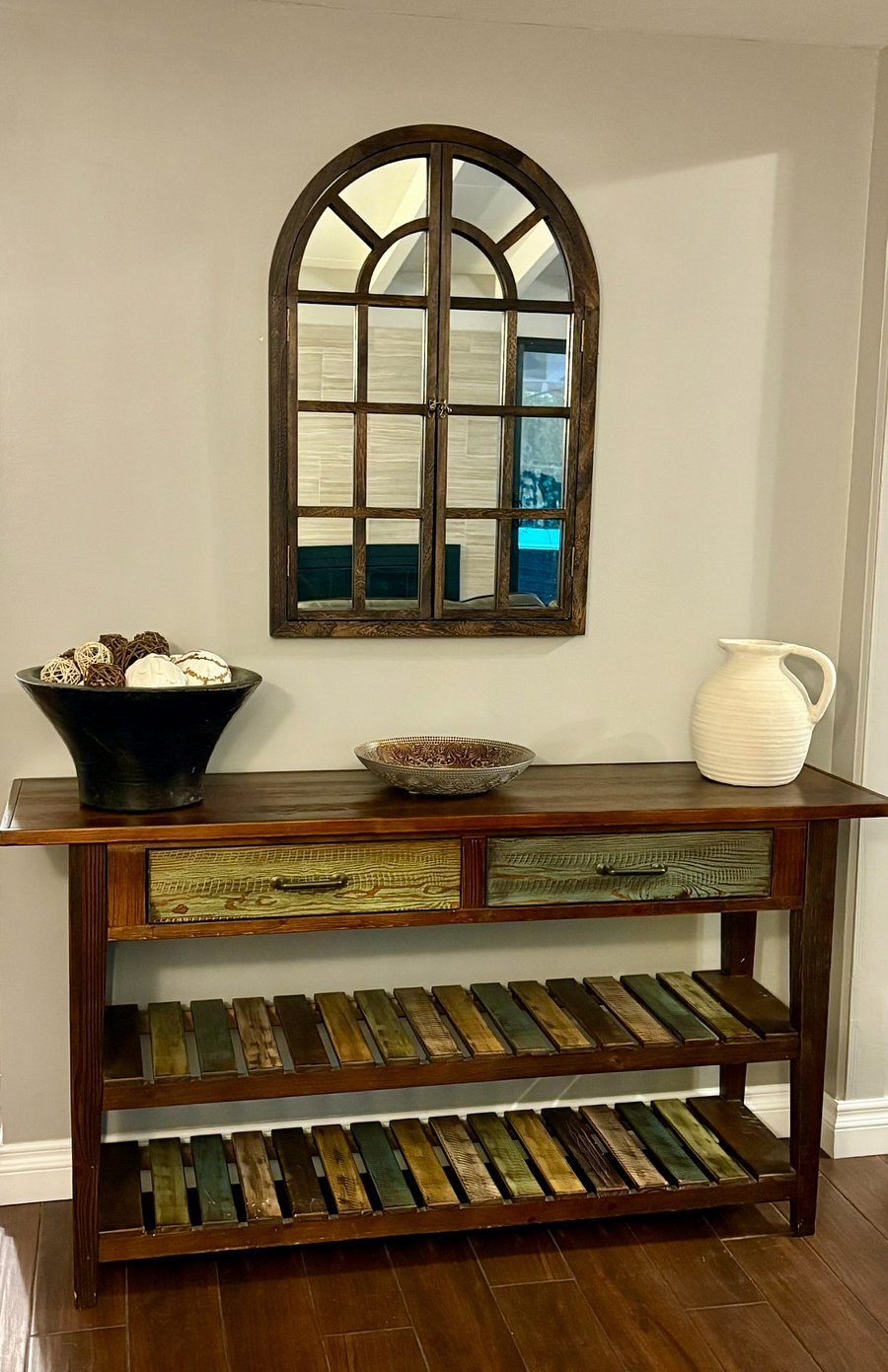 A thoughtful welcome. The reclaimed wood console and arched mirror set the tone the moment you enter the home.