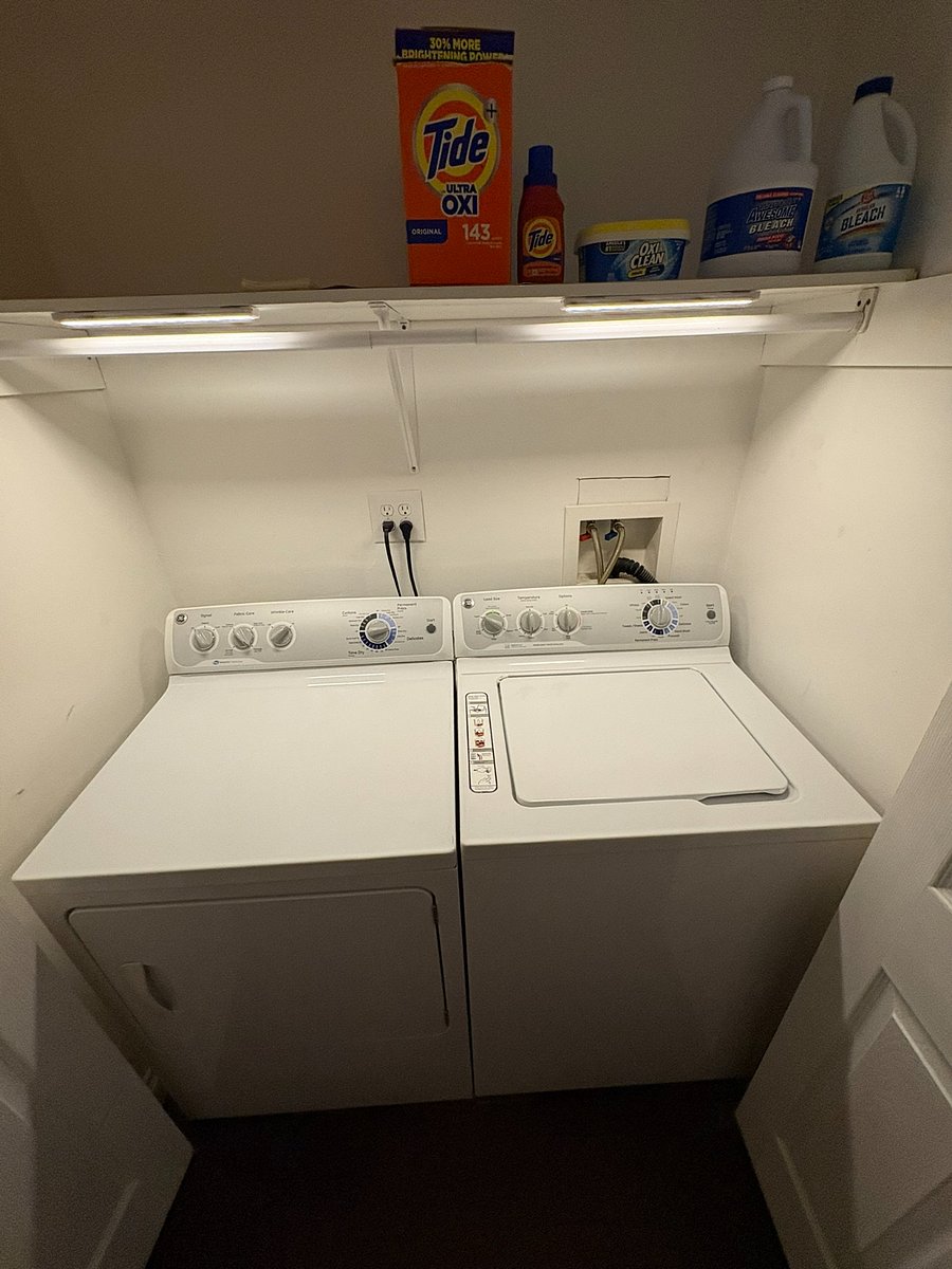 Full-size washer and dryer, stocked with detergent and supplies. 