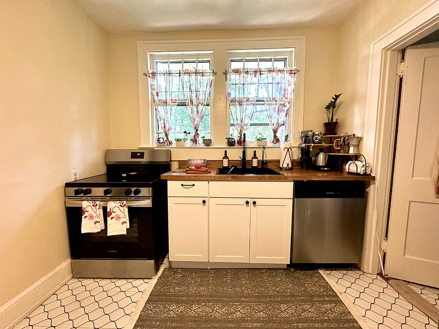 Kitchen with butcher block countertops and upgraded appliances.