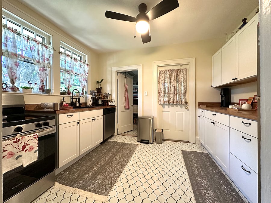 Kitchen with butcher block countertops and upgraded appliances.
