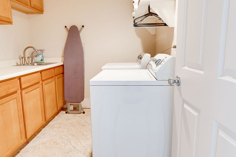 Full washer / dryer room with iron and ironing board