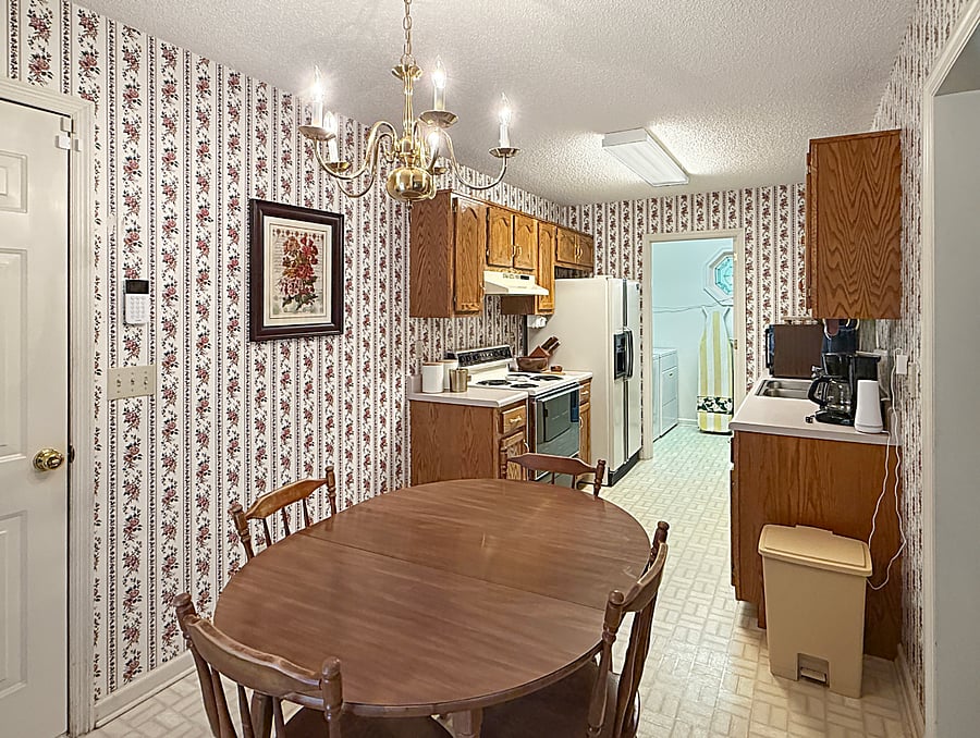 Kitchen with dining area and direct access to laundry room, garage and back deck