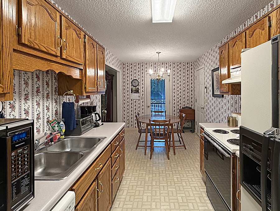 Kitchen with dining area and direct access to laundry room, garage and back deck