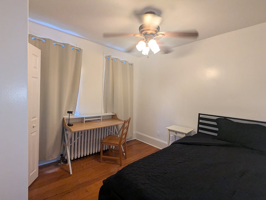 Rear bedroom - Twin XL bed, hardwood floors, desk & chair workstation, dresser with built-in closet.