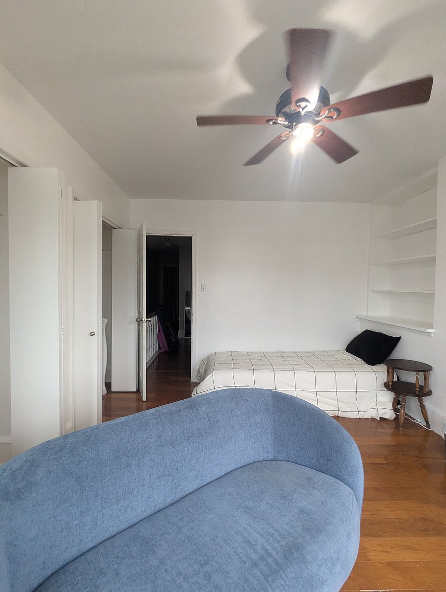 Front bedroom (single deluxe) - Twin XL bed, hardwood floors, desk & chair workstation,  2 large closets with dresser and built-in storage shelves. This deluxe room also includes a private sitting area with loveseat sofa, TV and side table.