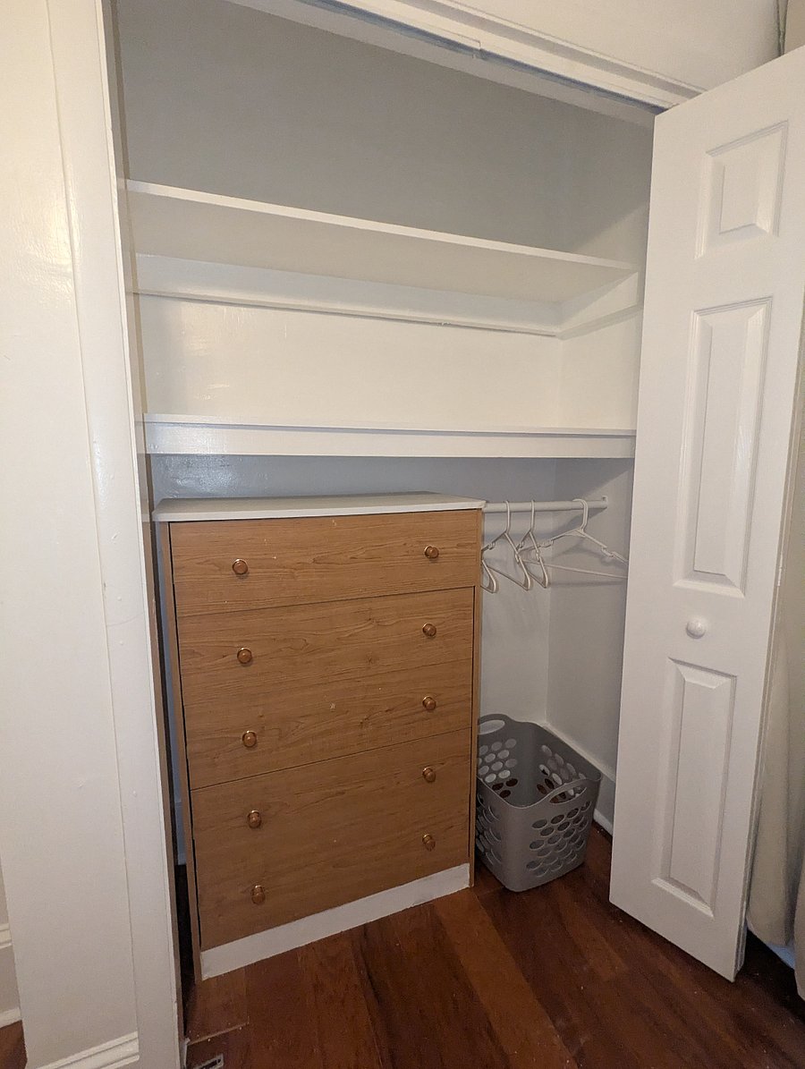 Rear bedroom - closet with built-in shelves, dresser and closet storage.