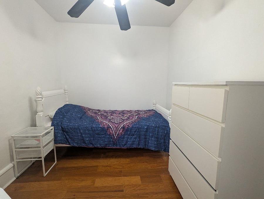 Middle bedroom - includes Twin XL bed, workstation, dresser and closet storage.