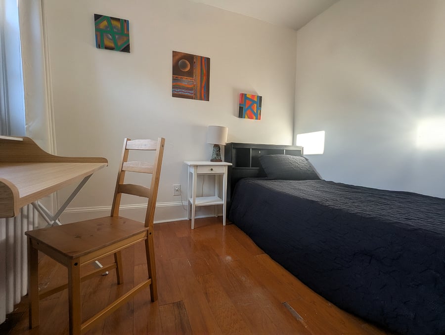 Rear bedroom - Twin XL bed, hardwood floors, desk & chair workstation, dresser with built-in closet.