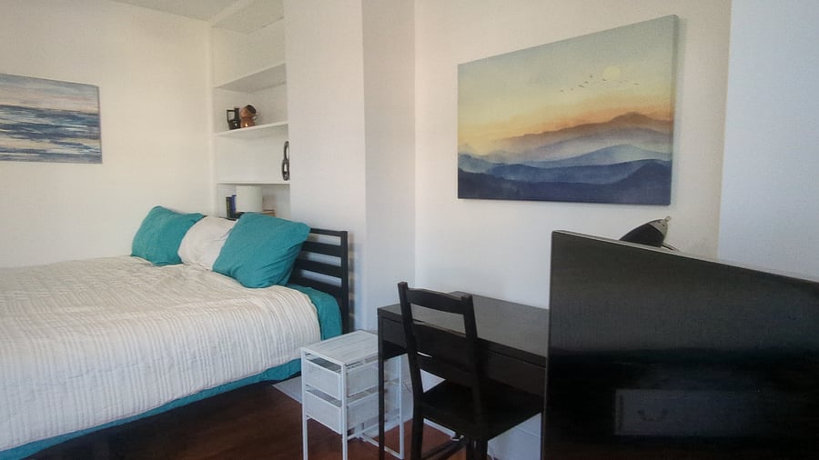 Front bedroom (Single Deluxe) - Twin XL or King bed (shown) desk & chair workstation.
