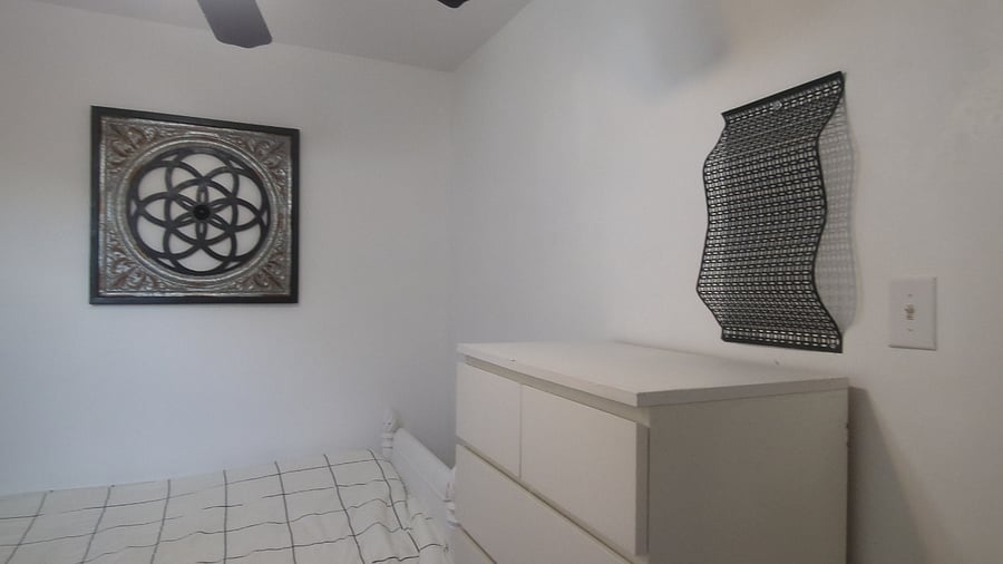 Middle bedroom - includes Twin XL bed, workstation, dresser and closet storage.
