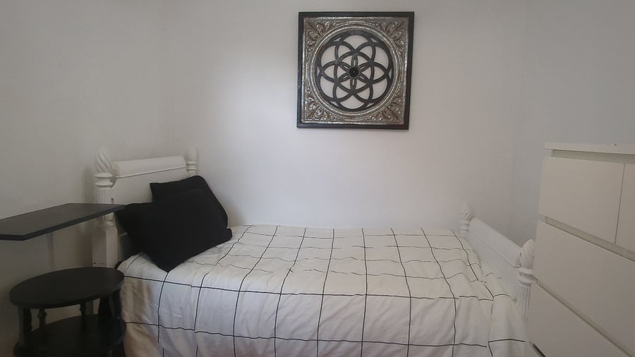Middle bedroom - includes Twin XL bed, workstation, dresser and closet storage.