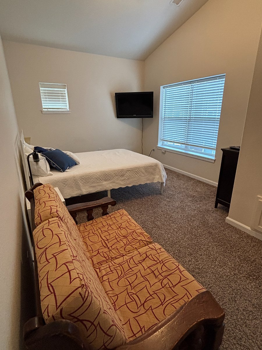 Queen bedroom with loveseat.