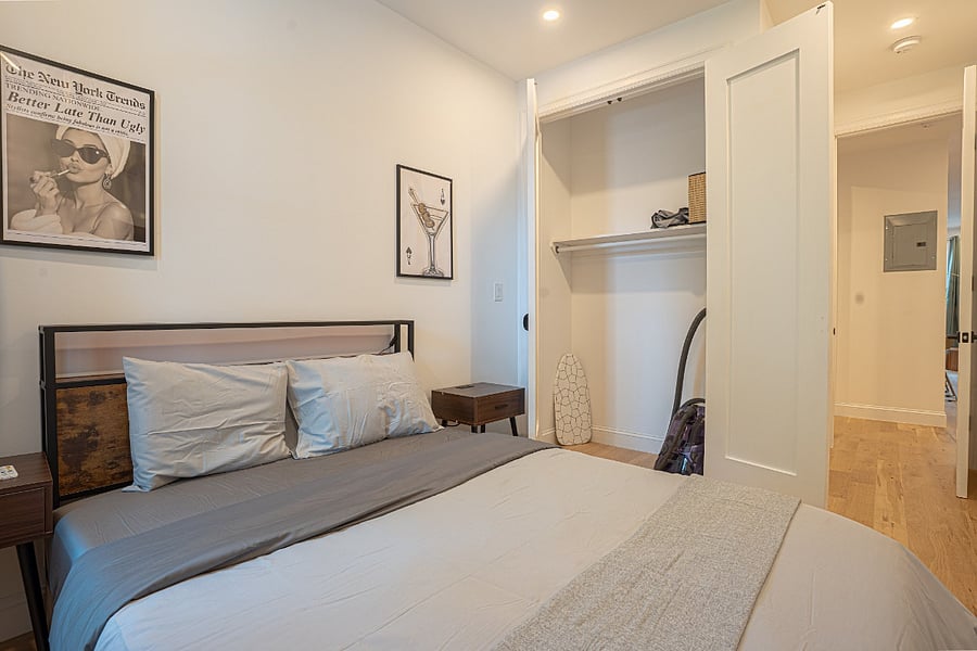 Bedroom 2 - queen bed with open closet and shelving