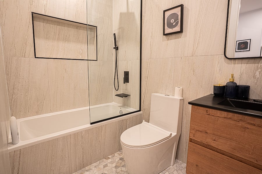 Main bathroom - stone-tile shower and modern vanity