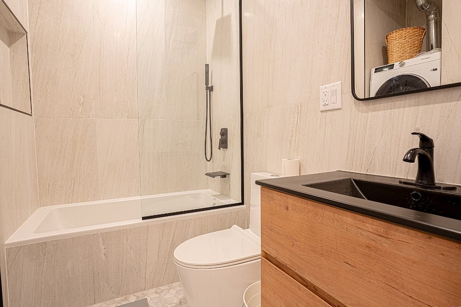 Bathroom 1 with soaking tub and matte-black fixtures