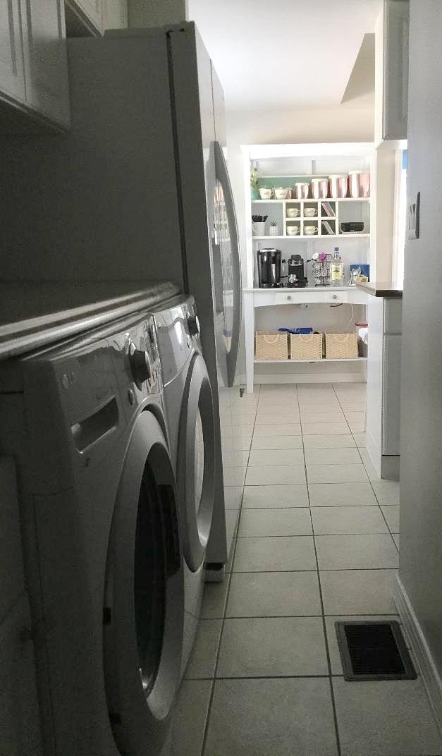 Washer/dryer with folding surface and cabinets.