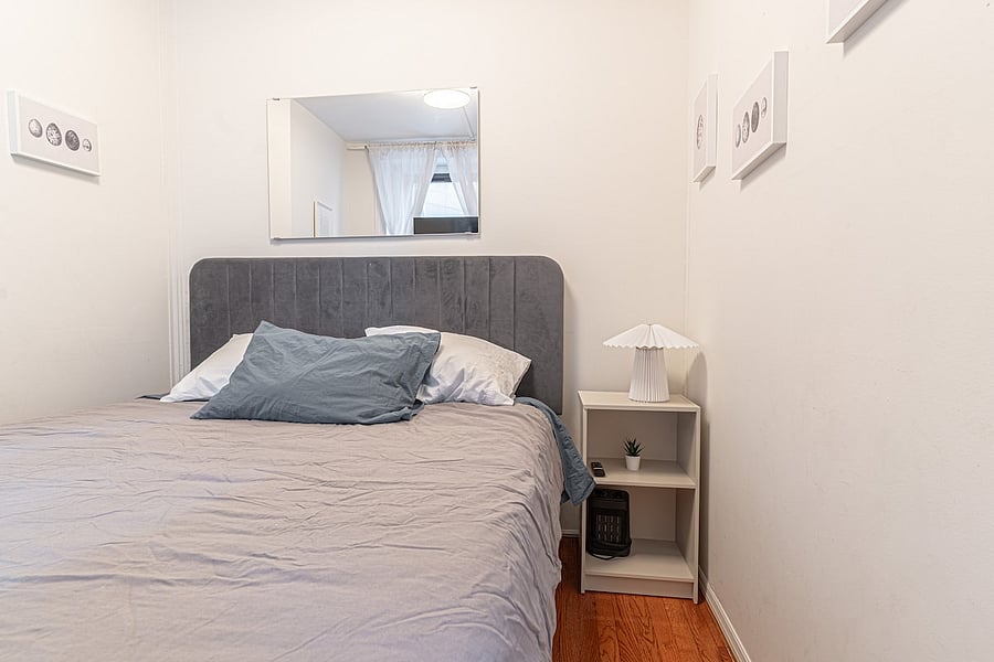 Comfortable bedroom with dresser, workspace nook & curated art