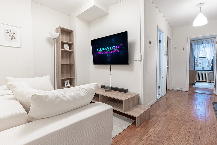 Bedroom with mirrored wardrobe storage & easy access to the living area