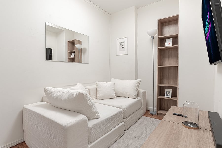 Open hallway with smart TV, media console & stylish decor accents