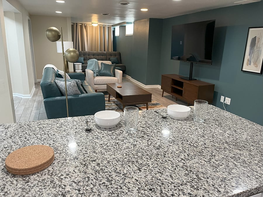 Enjoy breakfast, coffee, or remote work at the granite breakfast barwhile taking in the stylish living room with a smart TV and mid-century flair.