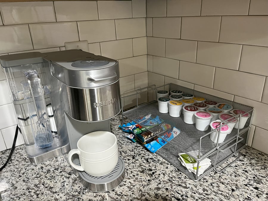 Start your morning right with a fully stocked Keurig stationfeaturing coffee, tea, cocoa, and sweet treats, all ready when you are.