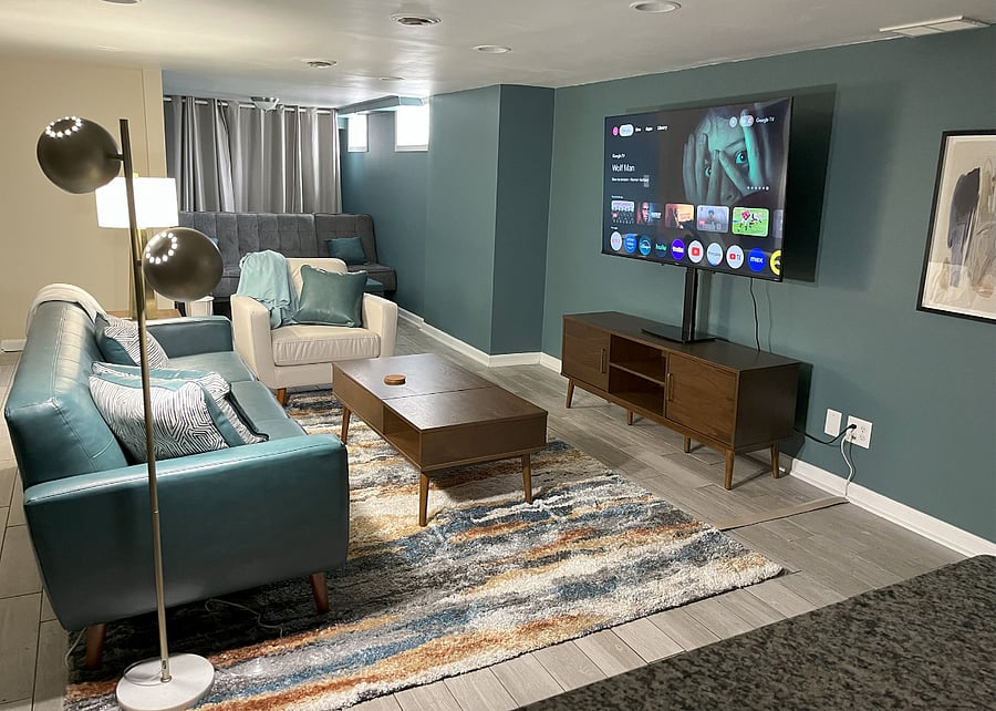 Spacious open-concept living area with leather sofa, armchair, and sleeper sofagreat for lounging, streaming, or accommodating extra guests.