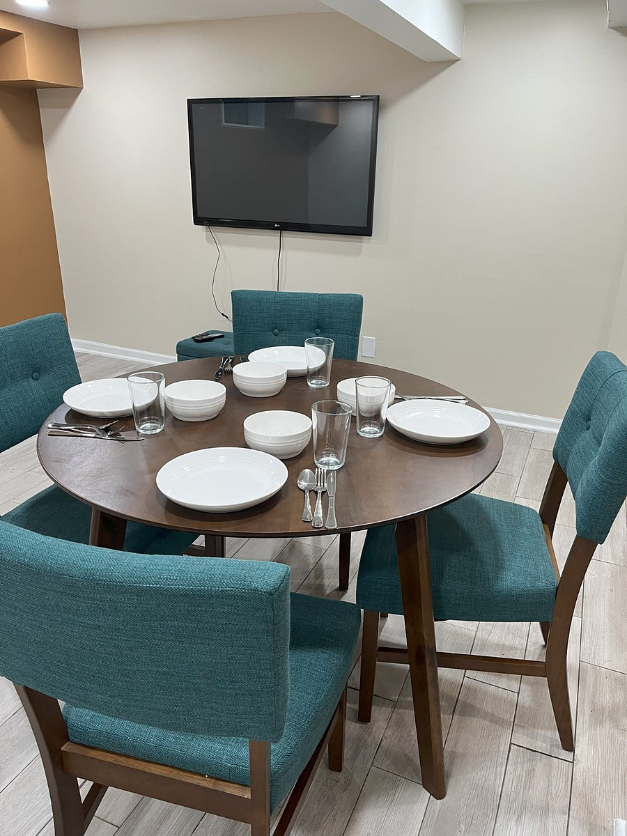 Enjoy meals or remote work at the round dining table with seating for fourcomfort and versatility in a thoughtfully designed space.