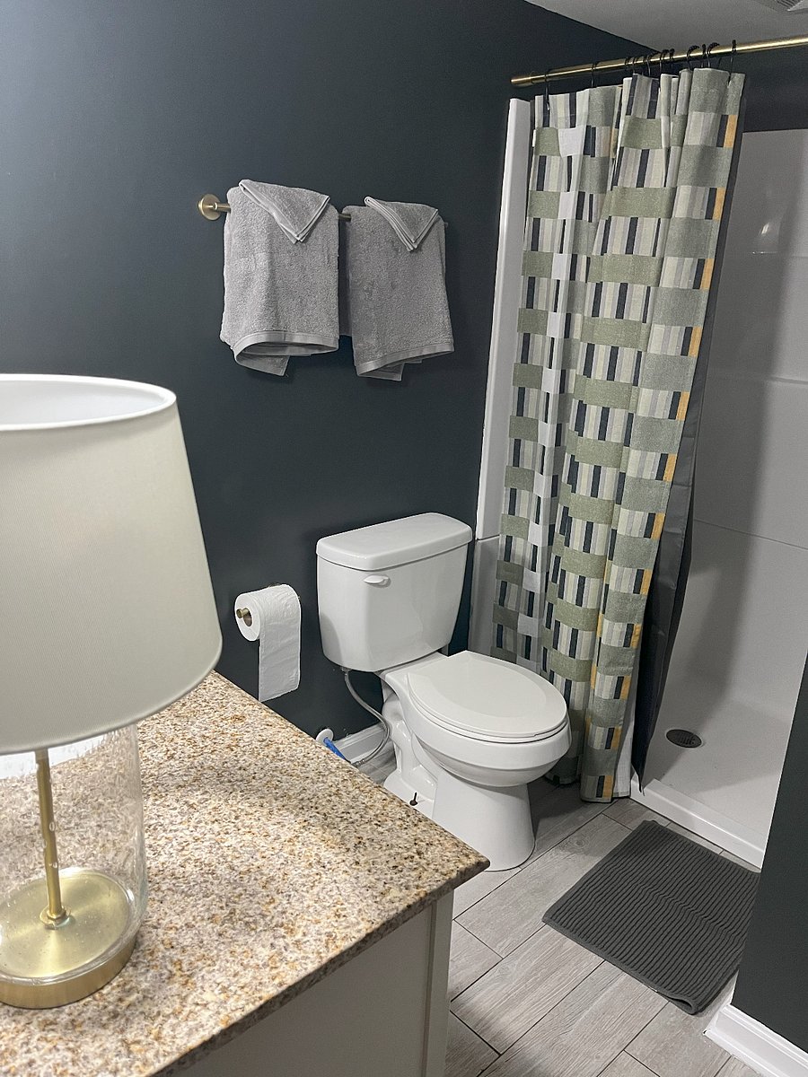 Bright, modern bathroom with walk-in shower, soft towels, and brushed gold finisheseverything you need for a comfortable stay.