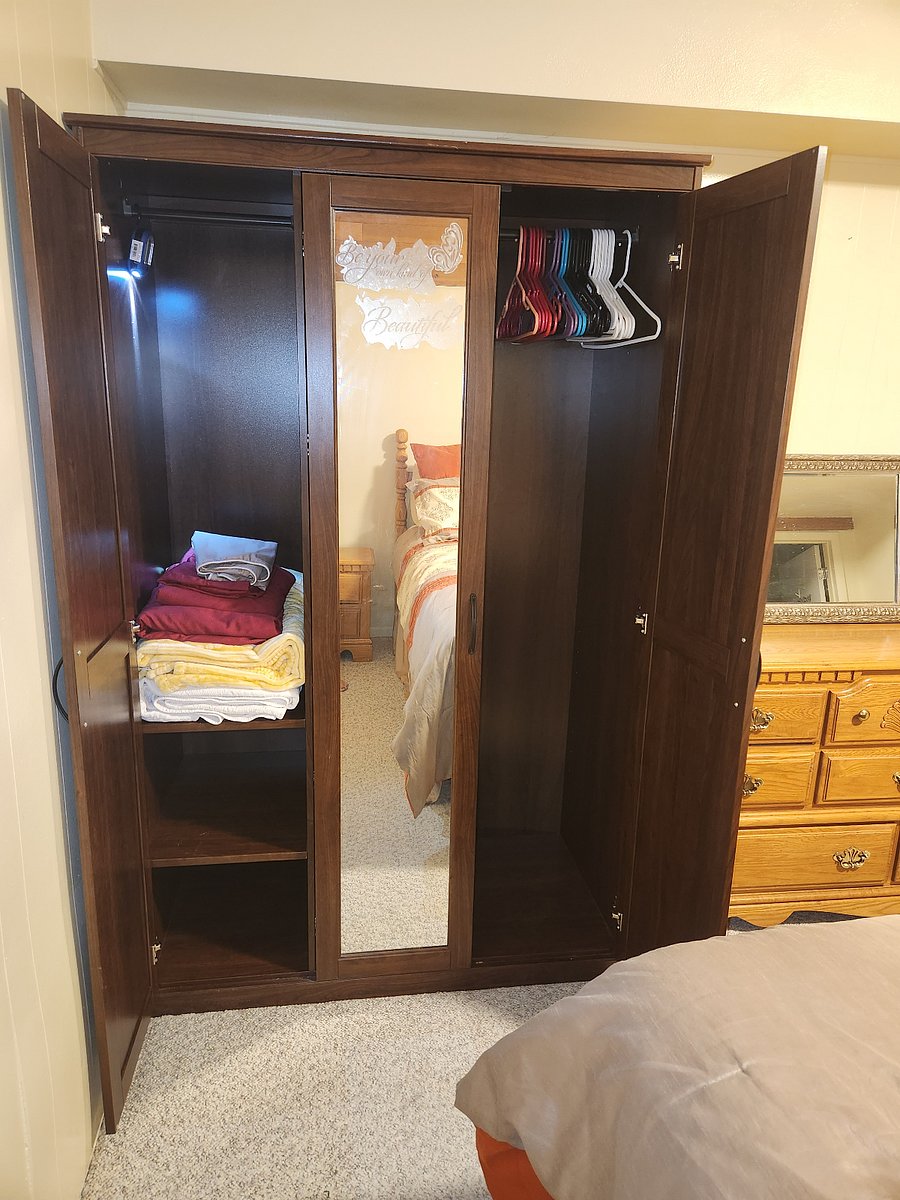 Bedroom Closet Door Open (bed linens inside)