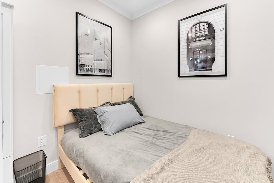 Queen bedroom with crisp linens and gallery-style artwork.