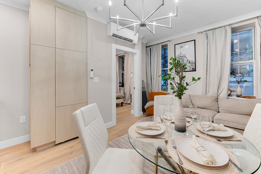 Living and dining space with glass table  entertain, work, or unwind in style.