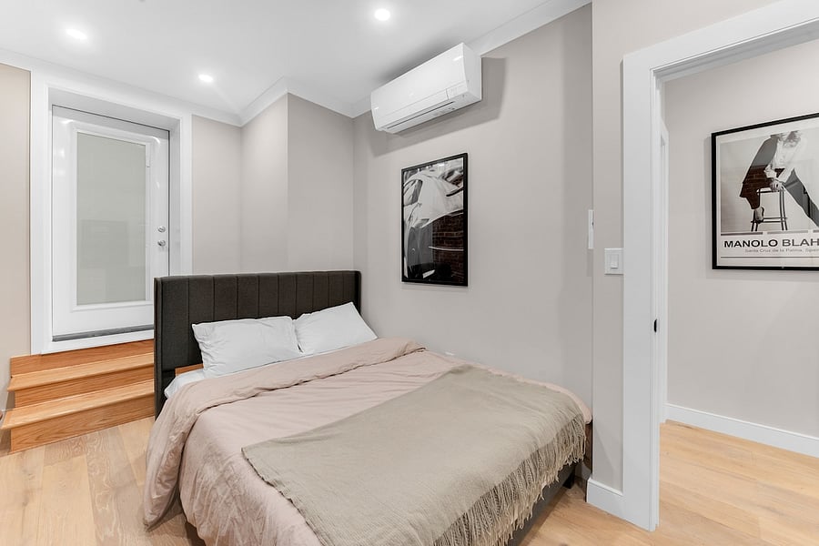 Calming queen bedroom with mini-split A/C and blackout comfort.