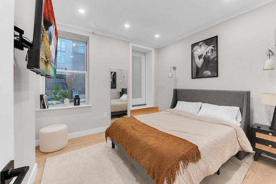 Bright bedroom with oversized window and designer touches.
