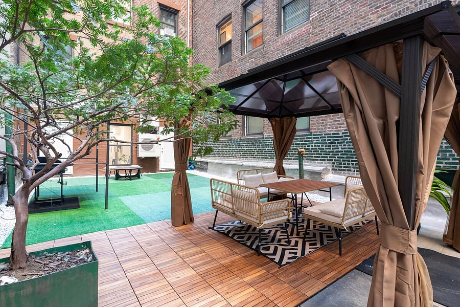 PRIVATE TERRACE  wood-deck dining lounge under a curtained pergola, all yours.