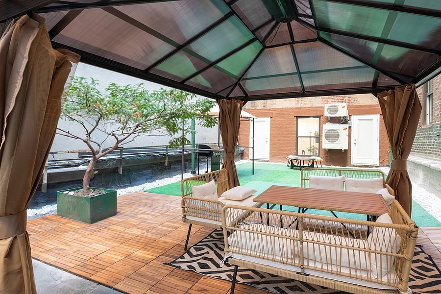 Terrace lounge seating beneath the glass-roof pergola  morning coffee to evening unwind.