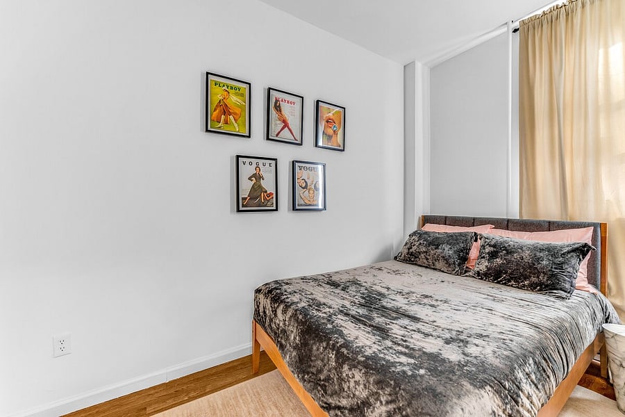 Queen bedroom with plush bedding and curated art.