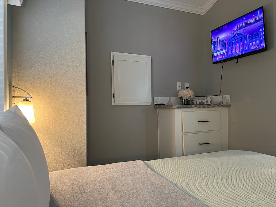 Unwind in a cozy master bedroom with a new queen bed, TV, blackout curtains, and closet and drawer spaceideal for a peaceful nights sleep or movie night in.