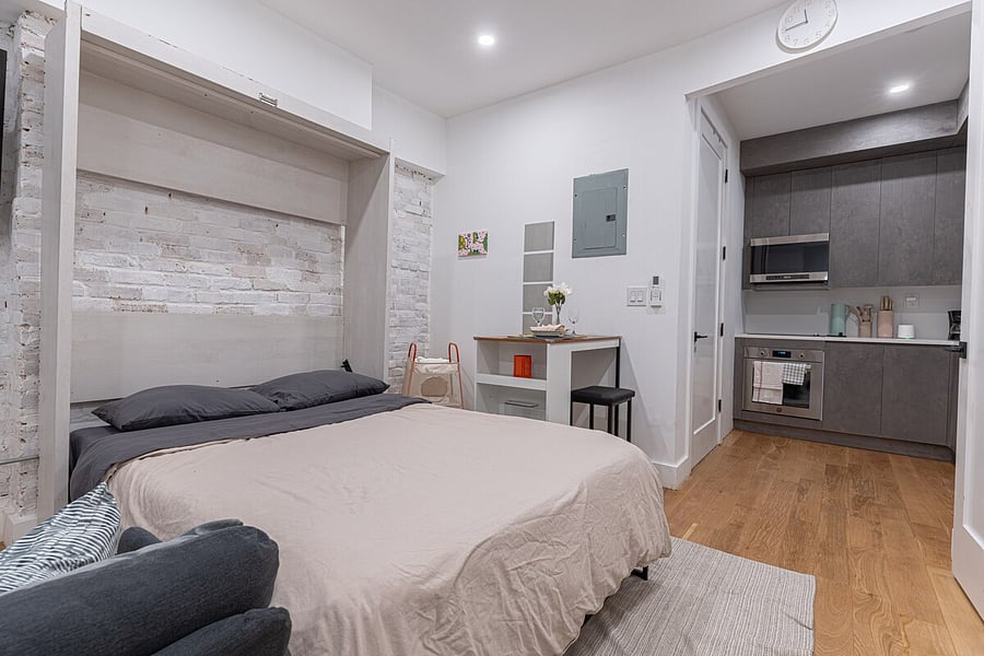 Renovated kitchen with quartz counters, deep sink and open shelving  fully stocked so you can cook at home.